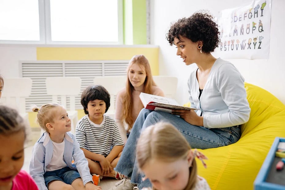 Education with good character and morals: woman reading a book to the children